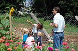 Two adults and three children looking around the Sugartown Garden